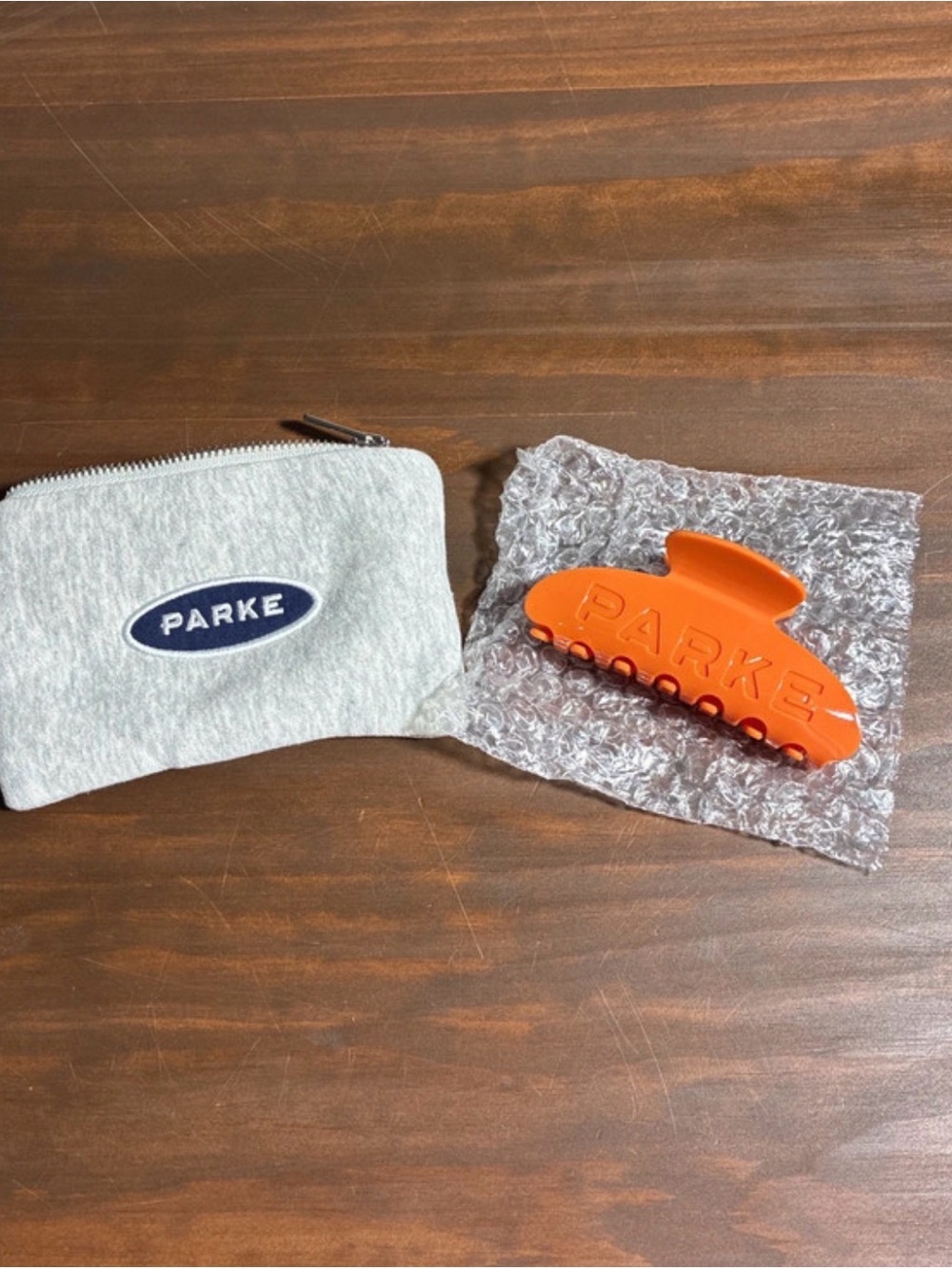 PARKE Orange Hair Claw Clip with Gray Logo Pouch